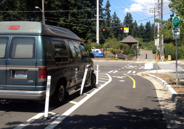 Pylons + car on the cycle track