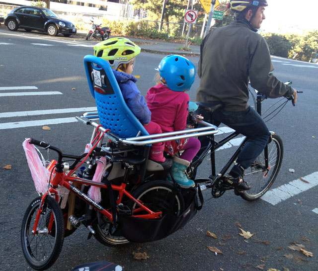 Tom towing two kid bikes