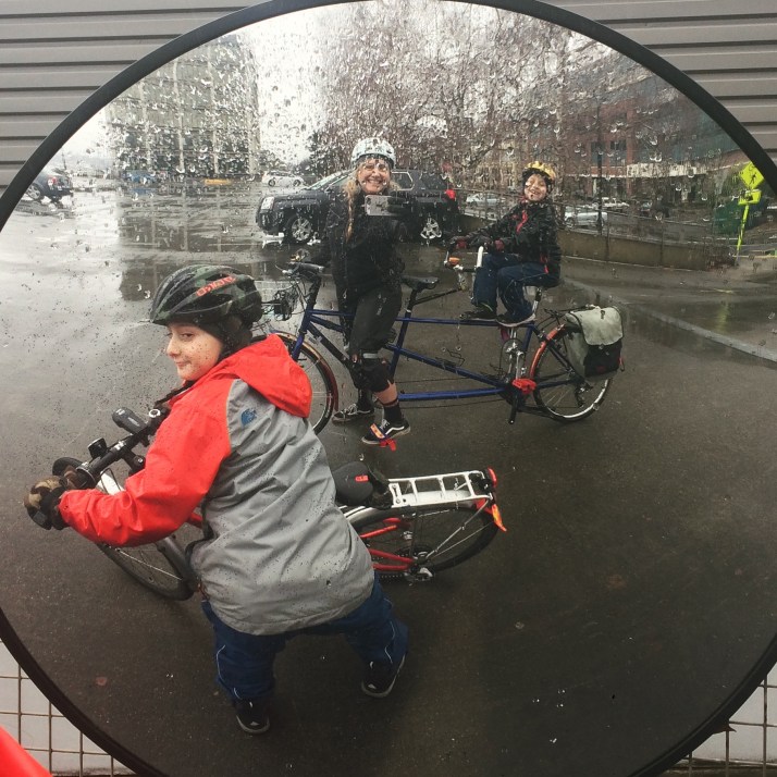 Circle mirror selfie of tandem and 24-inch bike